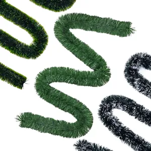 Close-up detail of vibrant green and dark green Christmas tinsel garlands for decor.