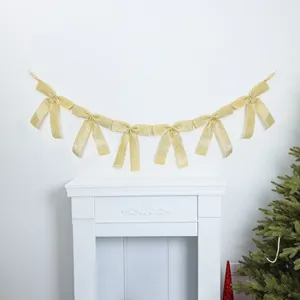 Close-up detail of a shimmering gold glitter bow garland for party wall decoration