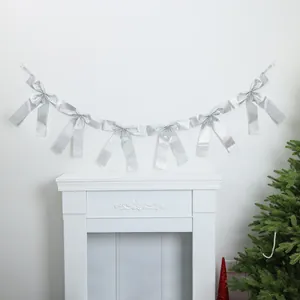 Shiny silver bow ribbon garland hanging as Christmas festive party wall decoration