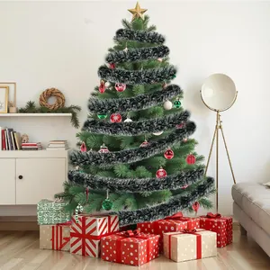 Close-up of black fluffy Christmas tinsel garland wrapped around a green festive tree