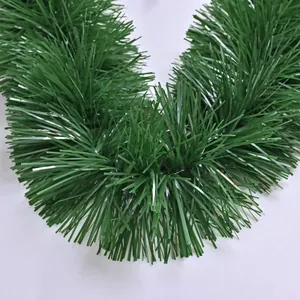 Detailed close-up of green artificial Christmas tinsel garland for holiday decor