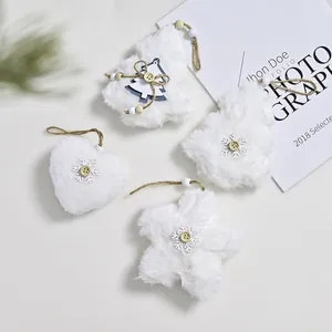 Detailed view of white plush Christmas heart star and tree shaped hanging ornaments