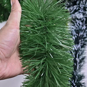 Macro view of green artificial Christmas garland showing the dense tinsel texture