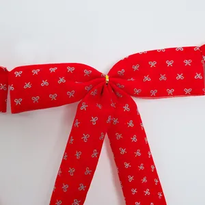 Detailed view of red ballet style ribbon bow with silver glitter patterns for decor