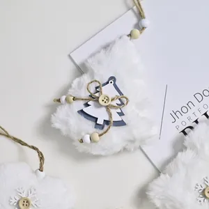 Detailed shot of white plush Christmas tree ornament with rustic wooden button