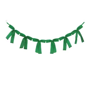 Detailed view of the sparkling green glitter ribbon bow garland for party decor