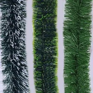 Detail view showing three different styles of green artificial Christmas tinsel garlands.
