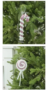Detailed view of pink glitter candy cane and lollipop ornaments on a Christmas tree.