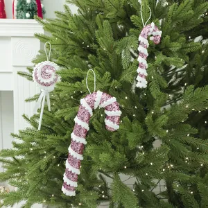 Pink and white glitter candy cane and lollipop Christmas ornaments for festive tree decor.