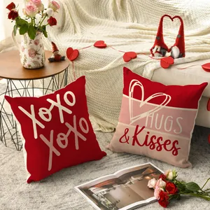 Close-up of Valentine's Day pillowcases with heart and XOXO prints in a cozy room