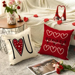 Decorative Valentine's Day throw pillow covers with heart motifs in a cozy living room