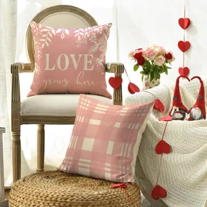 Romantic Valentine's Day scene featuring pink plaid and 'LOVE' message cushion covers