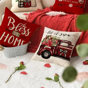 Cozy festive red and cream throw pillow covers with holiday designs in a home setting