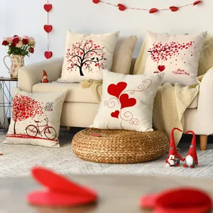 Detail view of Valentine's Day cushion covers with red heart patterns on a sofa.