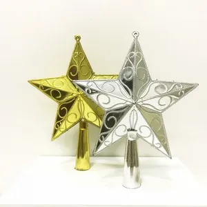 Detail showing metallic gold and silver Christmas tree topper stars with intricate swirls