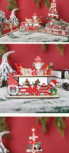 Detail of wooden Christmas gnomes and Xmas letter ornaments on a snowy background.