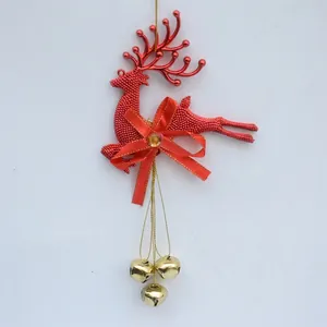 Detailed view of red Christmas reindeer ornament with golden bells and bow decoration.