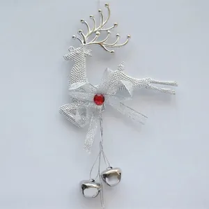 Detail of silver reindeer Christmas ornament with red gem, bow and metal bells