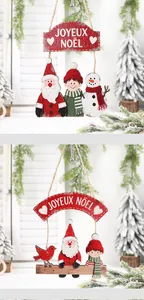 Detail of wooden Christmas door hangers with Santa and Joyeux Noël greeting signs