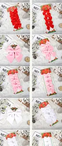 Set of festive velvet Christmas bows in red, pink, and white for holiday tree decorations