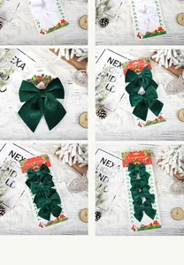Detail showing various sizes of dark green velvet Christmas bows on display cards