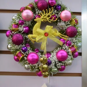 Elegant festive Christmas wreath featuring a golden reindeer and pink purple baubles