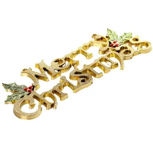 Elegant golden Merry Christmas sign with holly leaves for festive holiday tree decoration