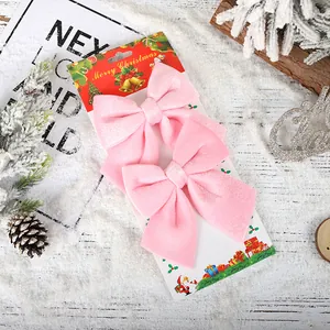 Set of two light pink velvet Christmas bow ornaments for festive holiday home decoration