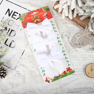 Set of three elegant white velvet Christmas bows for festive tree decoration and DIY crafts