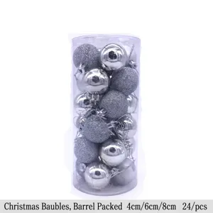 Close-up of 24 silver Christmas ornaments in a clear cylindrical pack, shiny and glittery.
