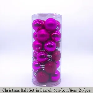 Close-up detail of 24 pink Christmas baubles packed in a clear cylindrical storage tube