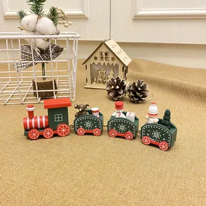 Decorative wooden Christmas train with snowman and tree figures on a burlap surface