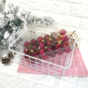 Vista dettagliata di un set di palline di Natale rosse da 4 cm in un cesto bianco