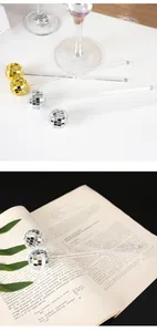 Detailed macro shot of 3cm gold and silver mirror disco ball cocktail stirrers party decor