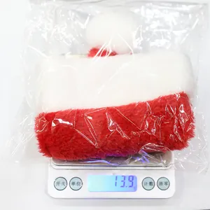 Soft red and white plush pet Christmas hat for cats and dogs weighing 13.9g on scale