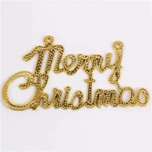 Close-up view of gold Merry Christmas letter plate ornament for holiday decoration