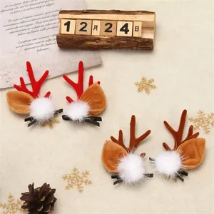Close-up of cute 3D Christmas reindeer antler hair clips on festive background