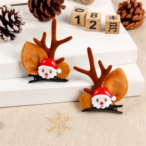 Close-up of cute Christmas reindeer antler hair clips with Santa Claus