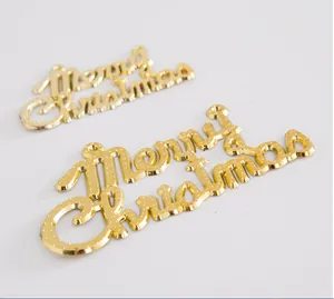 Detail of golden Merry Christmas signs with textured surface for holiday decoration