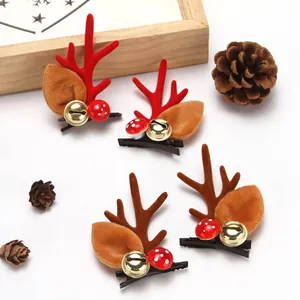 Close-up detail of festive Christmas reindeer antler hair clips with bells and pinecones