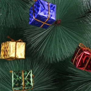 Detail view of colorful mini gift box ornaments hanging on a festive Christmas tree.