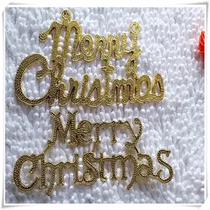 Close-up detail of golden plastic Merry Christmas letter signs for holiday tree decoration