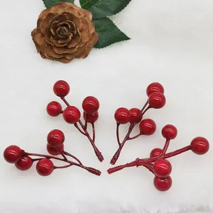Close-up detail of artificial red berries clusters for festive Christmas decorations