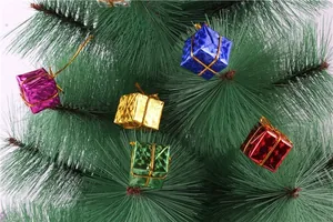 Detailed view of colorful mini foam gift box ornaments hanging on green Christmas tree branches