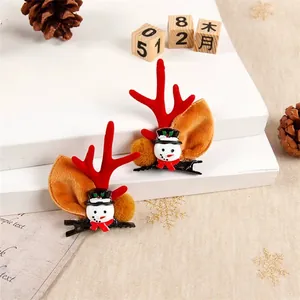 Detail view of festive Christmas reindeer antler hair clips with a cute snowman character
