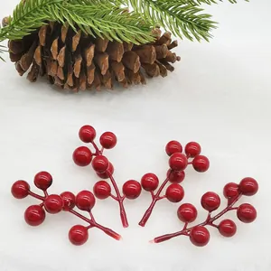 Detail view of four glossy artificial red berries for festive Christmas decorations