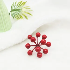 Detailed macro view of vibrant artificial red berry cluster for festive Christmas decoration