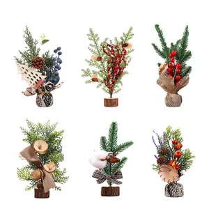 Zes mini kunstmatige kerstbomen met dennenappels, bessen en linten op witte achtergrond