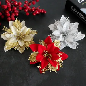 Macro detail of festive artificial poinsettia flowers with gold glitter accents