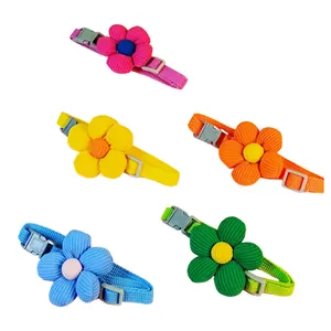 Detailed view of adjustable pet collars with colorful corduroy flower decorations.